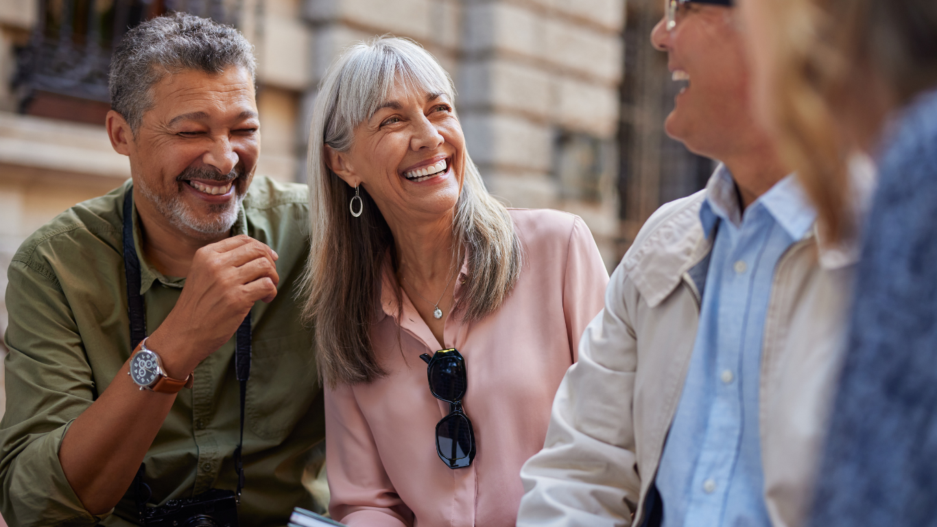 Three smiling seniors talking to one another