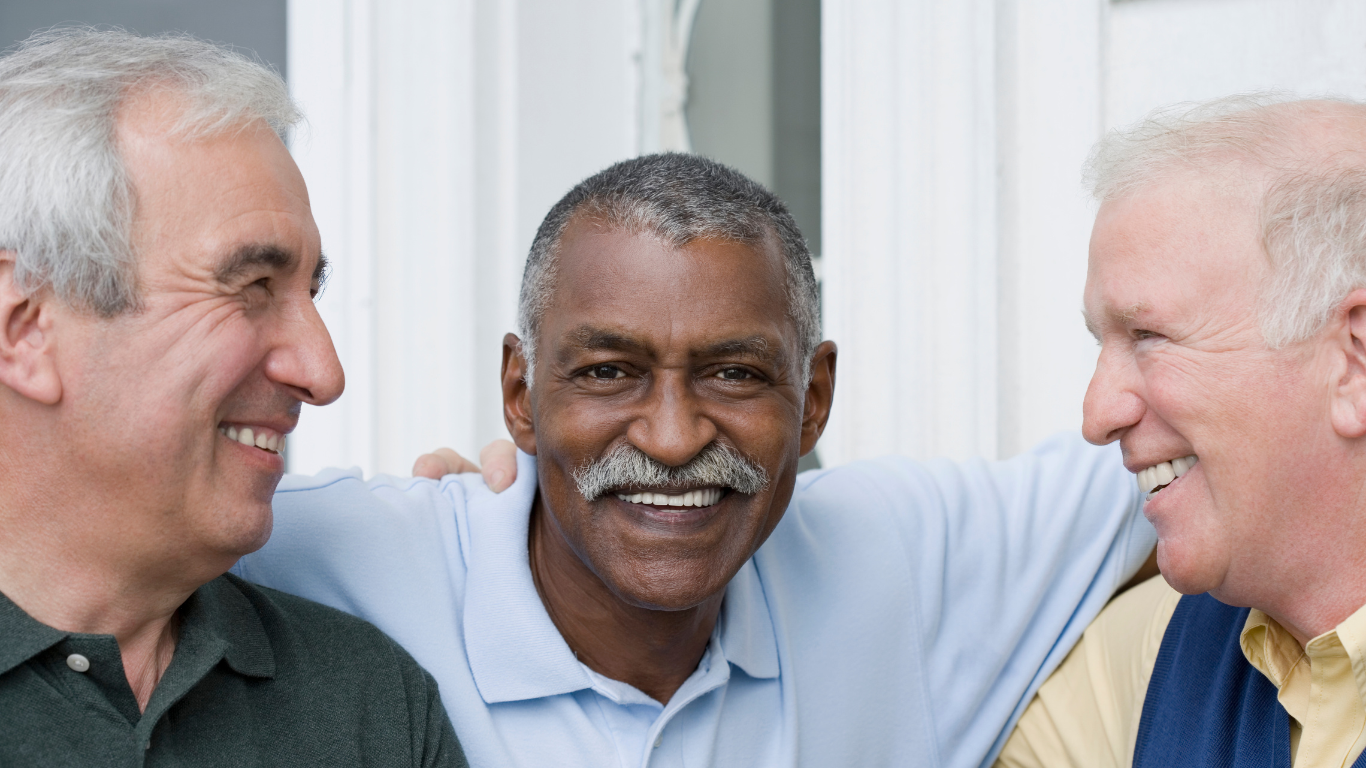 Group of senior friends smiling at one another