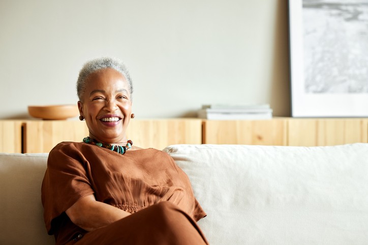 happy senior woman sitting on sofa