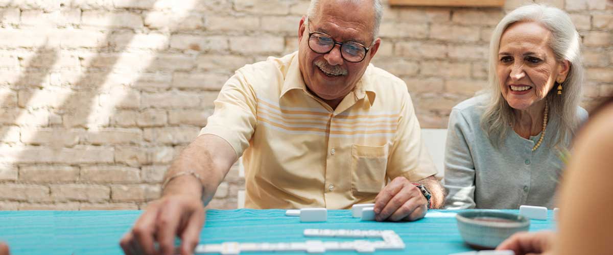 Senior couple playing dominoes