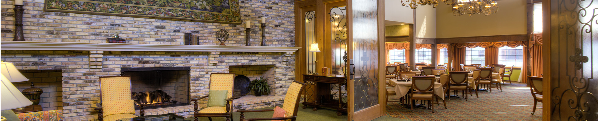 View of the formal dining room next to a common seating area beside a cozy fireplace.