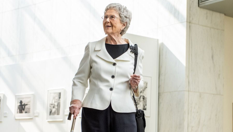 senior lady walking with a cane