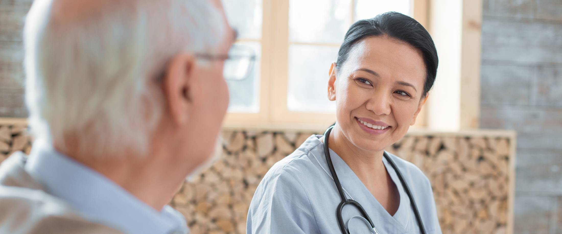 skilled nurse helping an elderly man in a skilled nursing facility