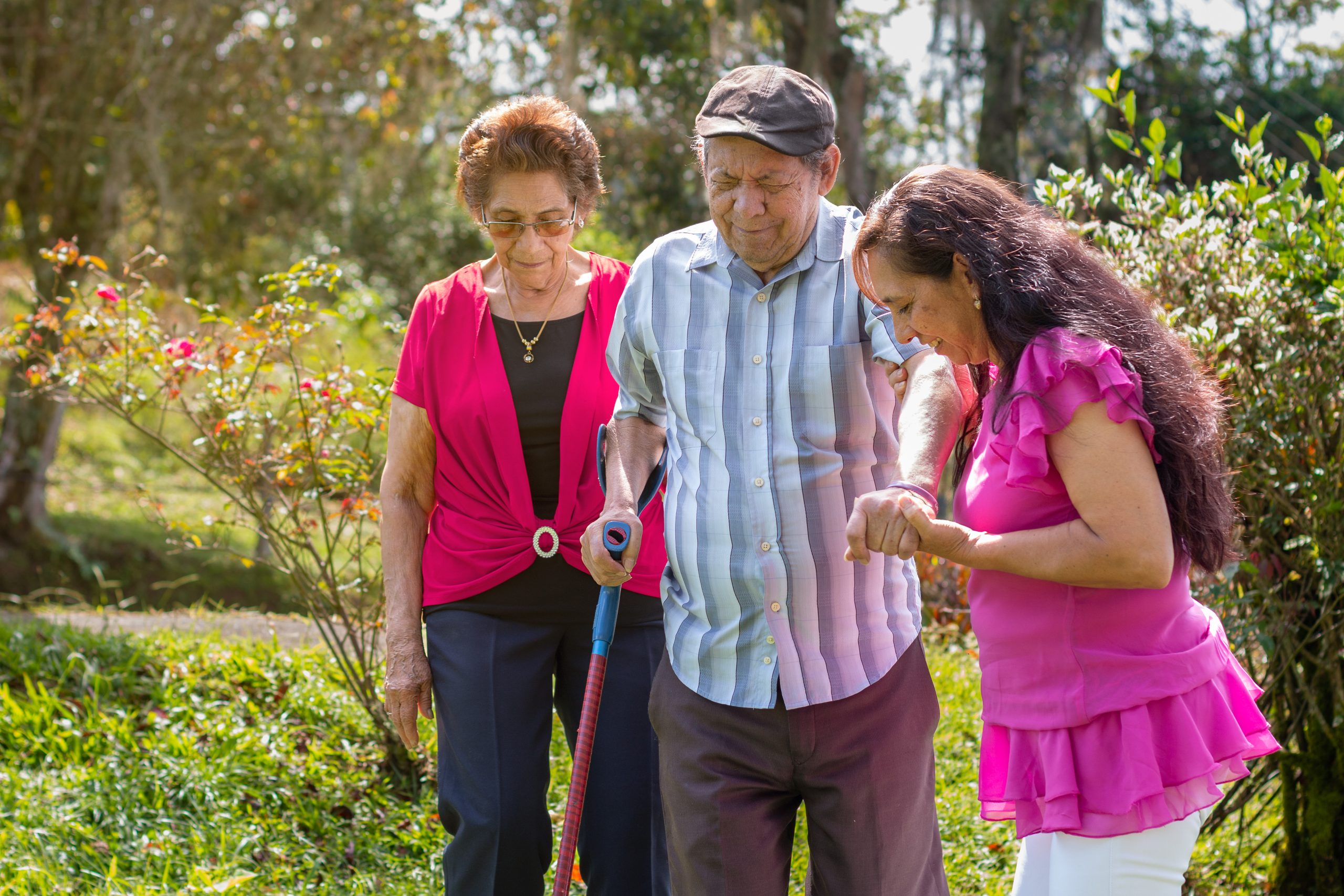 Adult daughter accompanying her senior parents on outdoor walk